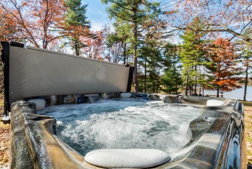 a jacuzzi hot tub in a park with trees at Sunset Cove in Swanton