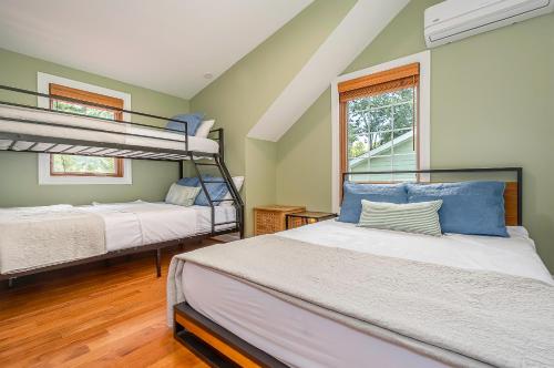 a bedroom with two bunk beds and a window at Sunset Cove in Swanton