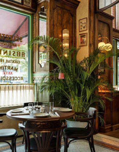 a restaurant with a table and chairs and a plant at ROOST Detroit in Detroit