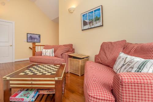 a living room with two couches and a chess table at Sunset Cove in Swanton