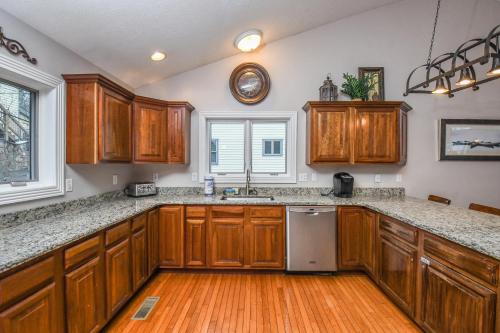 a kitchen with wooden cabinets and a sink and a window at Stone Crest in Oakland