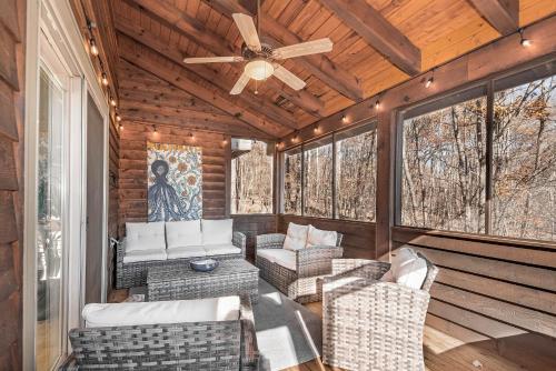 a screened porch with chairs and a ceiling fan at Play-A-Way Chalet in McHenry