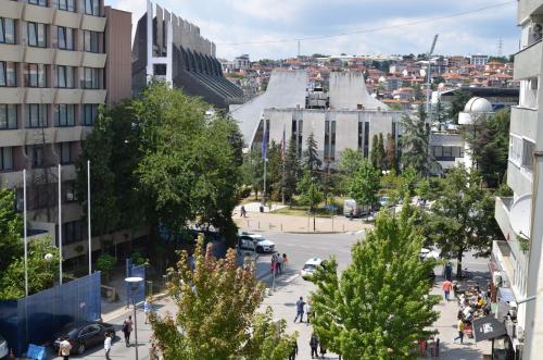 a street in a city with trees and a road at Center House Hostel in Pristina