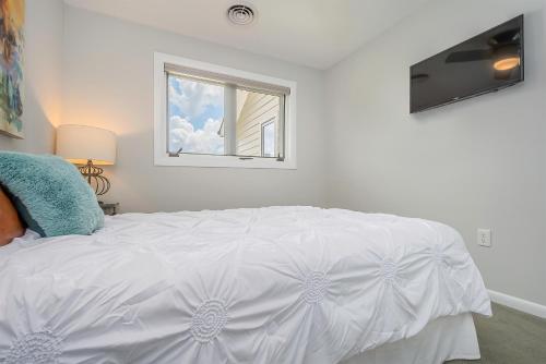 a white bed in a room with a window at Ski Harbor 11 in McHenry