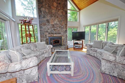 a living room with couches and a stone fireplace at Sunrise in Oakland