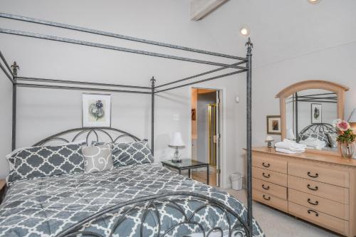 a bedroom with a bed and a dresser and a mirror at Sunset View in Swanton