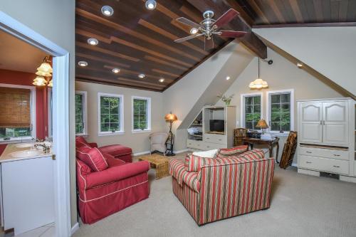 a living room with two chairs and a ceiling fan at Sunset View in Swanton