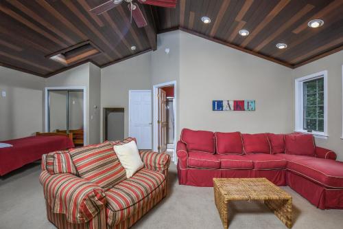 a living room with a red couch and a table at Sunset View in Swanton