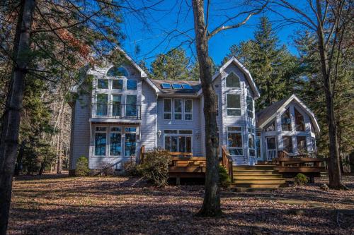 a house in the woods with trees at Sunset View in Swanton