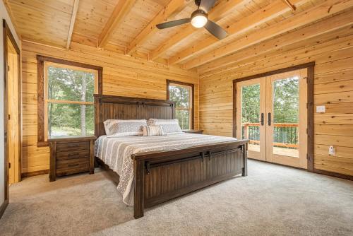 a bedroom with a bed and a ceiling fan at Sunshine Chalet in McHenry