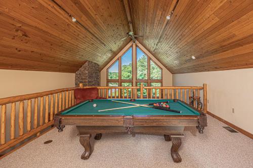 a pool table in a room with a wooden ceiling at Mountain Top Lodge in McHenry