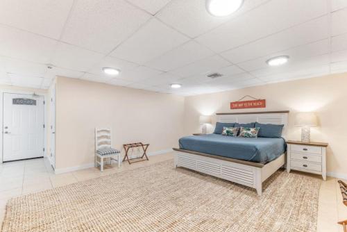a large bedroom with a blue bed and a rug at Island Time -- Oceanfront Bliss in Saint Augustine