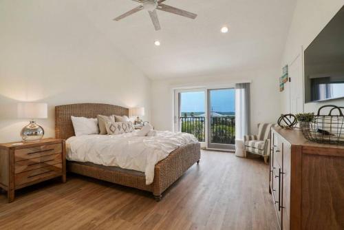 a large bedroom with a bed and a balcony at Crescent Lookout Oceanfront with panoramic views in St. Augustine
