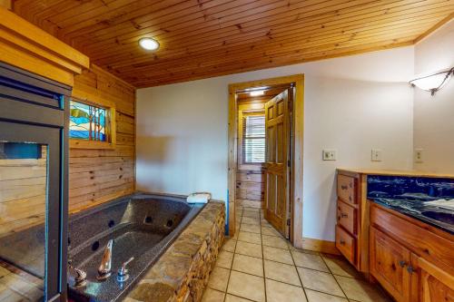 a large bathroom with a large tub in a cabin at Fantasy Mountain View in Sevierville