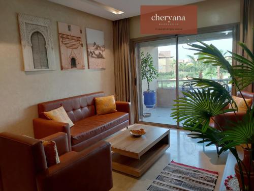 a living room with a couch and a coffee table at Prestigia Marrakech Golf 'Dar Cheryana' in Marrakech