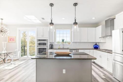 a kitchen with white cabinets and a large island at Waters Edge at Cortez in Saint Augustine