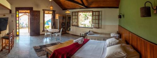 a bedroom with a large bed in a room at Pousada Barriga da Lua in Serra do Cipo