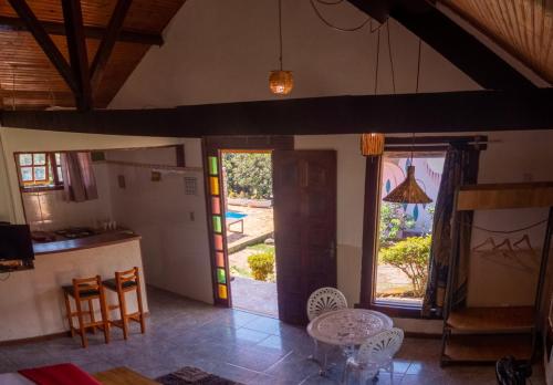 a kitchen with a table and chairs and a window at Pousada Barriga da Lua in Serra do Cipo