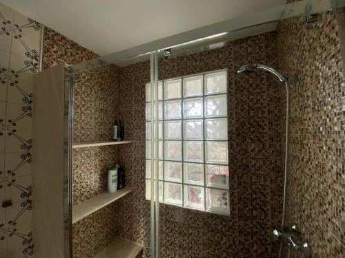 a bathroom with a shower and a glass shower backdoor at Lar dos Galos in Bueu