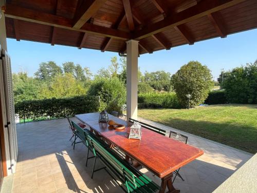 a wooden table and chairs on a patio at Paradise - nature and wellness in Pino Torinese