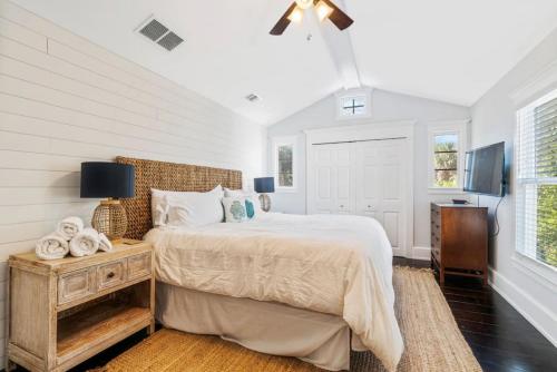 a bedroom with a bed and a table with a night stand at Lighthouse Retreat Island Beach Pool in Saint Augustine