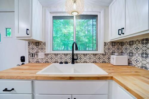 a kitchen with a white sink and a window at Scenic Drive Resort in Muskegon