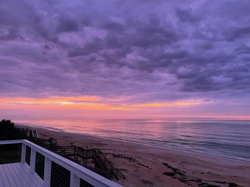 a view of a beach with a cloudy sky at Serenity One 100 percent Oceanfront 6 Bedrooms in Ponte Vedra Beach