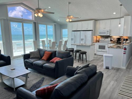 a living room with a couch and a kitchen at Serenity One 100 percent Oceanfront 6 Bedrooms in Ponte Vedra Beach