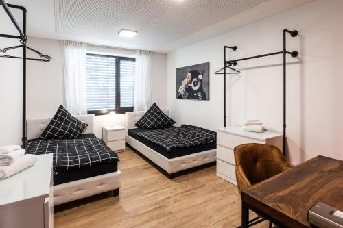 a living room with a bed and a couch at NECKARWESTHEIMER Appartement in Neckarwestheim