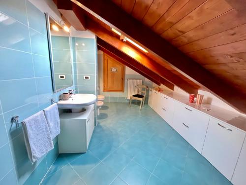 a bathroom with a white sink and a blue floor at Paradise - nature and wellness in Pino Torinese