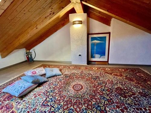 a bed with pillows on top of a large rug at Paradise - nature and wellness in Pino Torinese