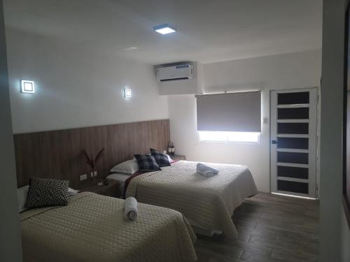 a hotel room with two beds and a window at Terramar Hoteles in Crucita