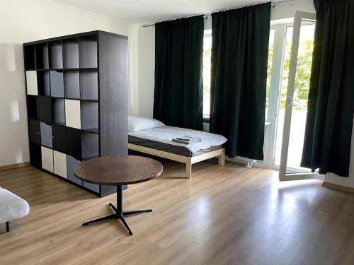 a bedroom with a bed and a table in a room at Elpke in Bielefeld