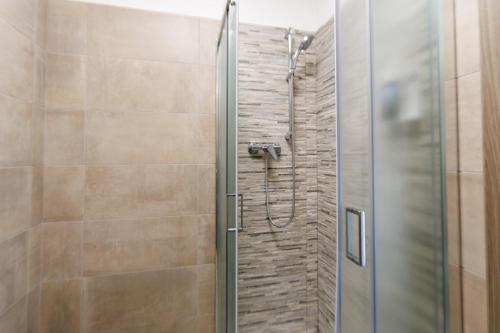 a shower with a glass door in a bathroom at Affittacamere Flavia Roma in Ostia Antica