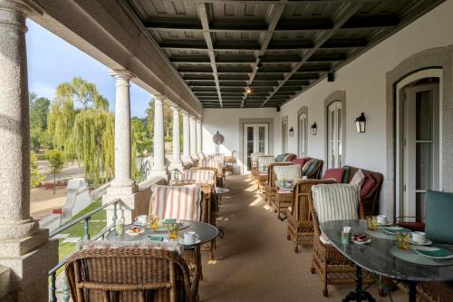 a row of tables and chairs on a porch at Valverde Santar Hotel & SPA - Relais & Châteaux in Santar