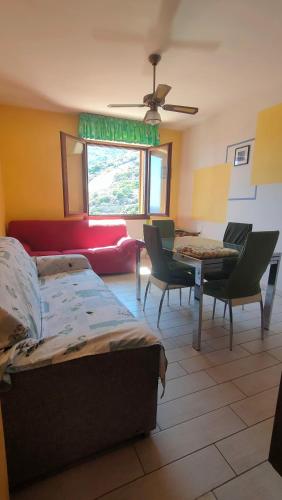 a living room with a bed and a couch and a table at Isola del Giglio casa Nico e casa Camilla Monticello Giglio Porto in Isola del Giglio