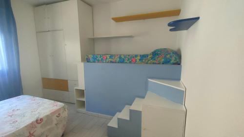 a room with a bed and a staircase in it at Isola del Giglio casa Nico e casa Camilla Monticello Giglio Porto in Isola del Giglio