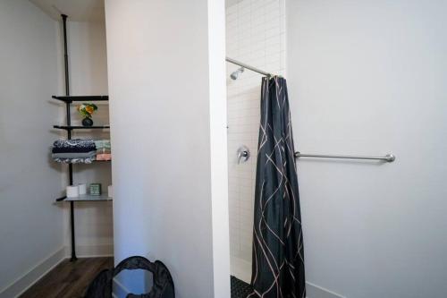 a shower with a tie hanging in a bathroom at COZY 1 bed/1 bath in Atlanta