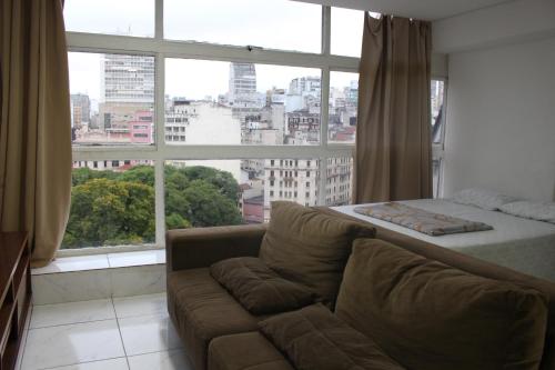 een woonkamer met een bank en een groot raam bij Best View 1413 in Sao Paulo