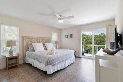 a bedroom with a bed and a ceiling fan at Treehouse By the Sea in St. Augustine