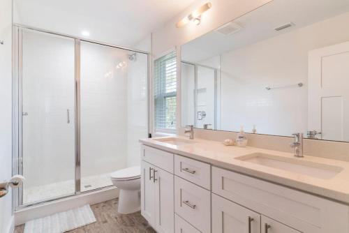 a bathroom with a sink and a shower and a toilet at Treehouse By the Sea in St. Augustine