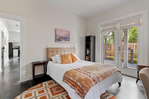 a bedroom with a large bed and a balcony at Whitefish Lodge in St. Augustine