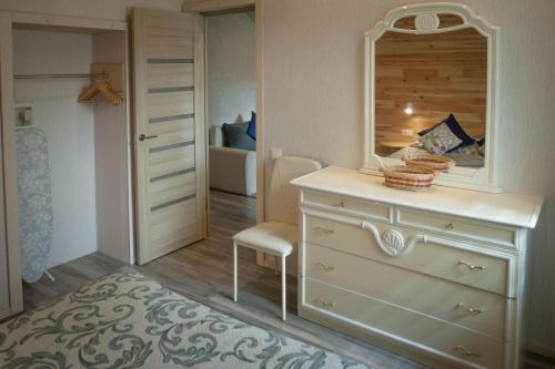 a bedroom with a dresser and a mirror at Lauku iela 25 in Jūrmala