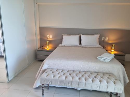 a bedroom with a large bed with two lamps at Life Tabatinga Beach-Flat com Wi-Fi in Conde