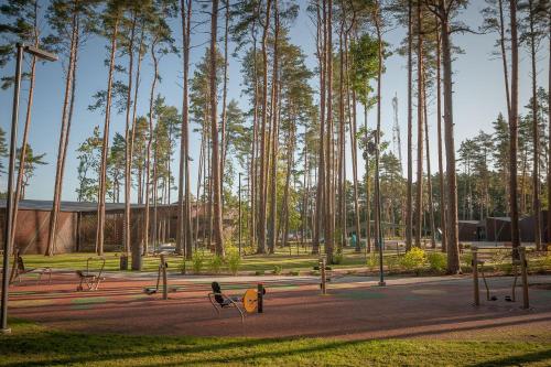 a park with a bunch of trees and benches at Lauku iela 25 in Jūrmala