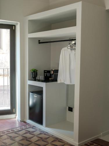 a living room with a tv in a wall at VICOLO SAN GAETANO -luxury rooms- in Catania