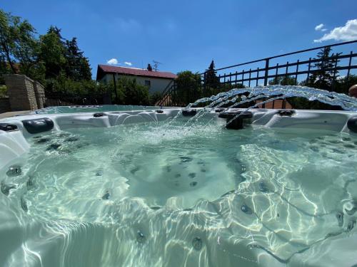 a hot tub with water coming out of it at Apartmány Sklepy Mařatice in Uherské Hradiště