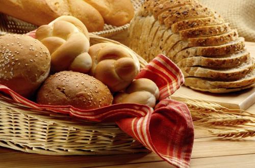 a basket filled with bread and other foods on a table at Hotel Alle Alpi in Moena