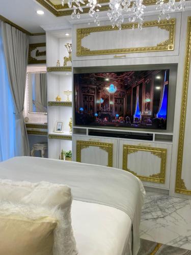 a bedroom with a bed and a flat screen tv at City View at The Gramercy Residences in Makati