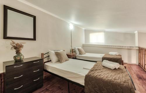 a hotel room with two beds and a dresser and a bed sidx sidx sidx at Sofia - Yiota Studios & Apartments in Tsilivi